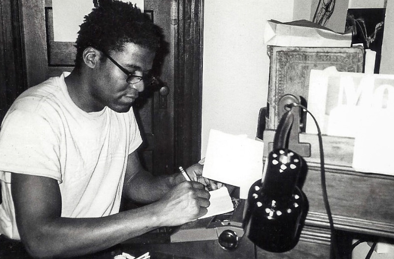 David Bethuel writing at a desk